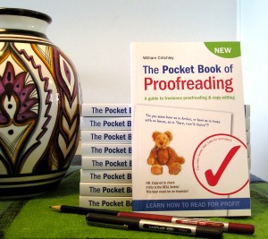 A copy of the Pocket Book of Proofreading with some pens