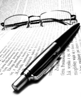 Spectacles and a pen lying on a book
